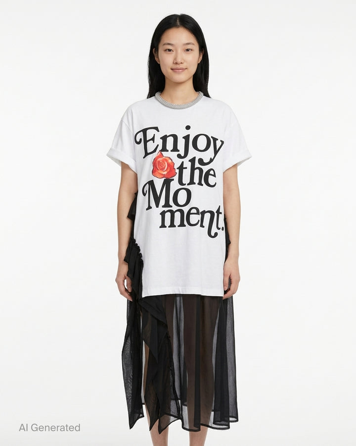 White oversized cotton tee dress with 'Enjoy the Moment' black lettering and a red rose graphic, crystal-embellished neckline and sheer black chiffon ruffle layers - front