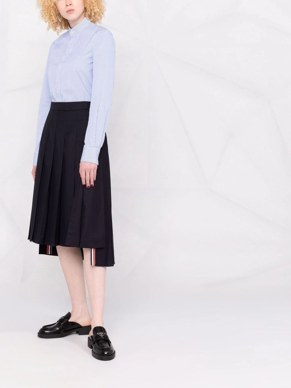 Thom Browne dark charcoal grey twill pleated midi skirt with high waistband and signature red, white, and blue stripe trim at the hem