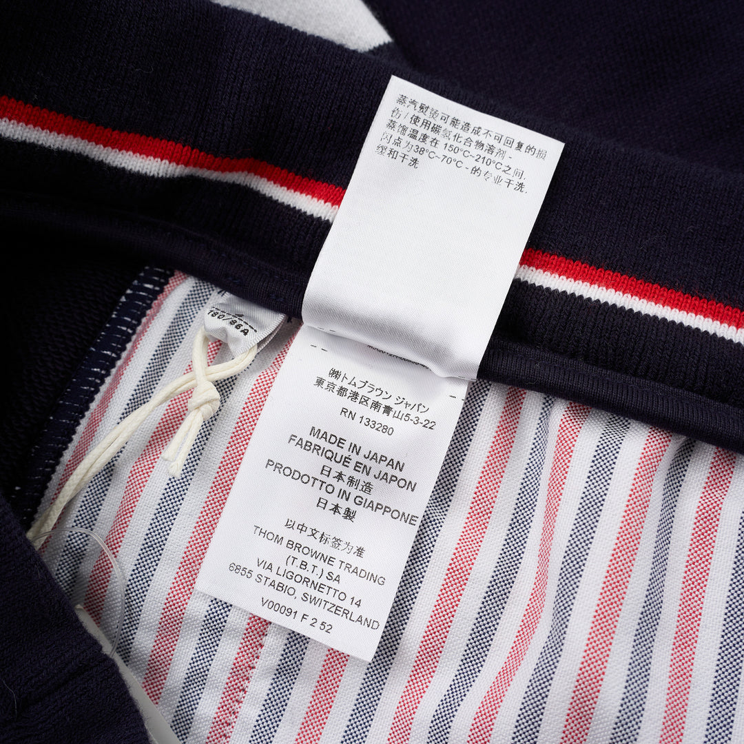 Thom Browne navy cotton sweat shorts with drawstring waist, white 4-Bar stripe on one leg and woven label patch at the hem - view 5