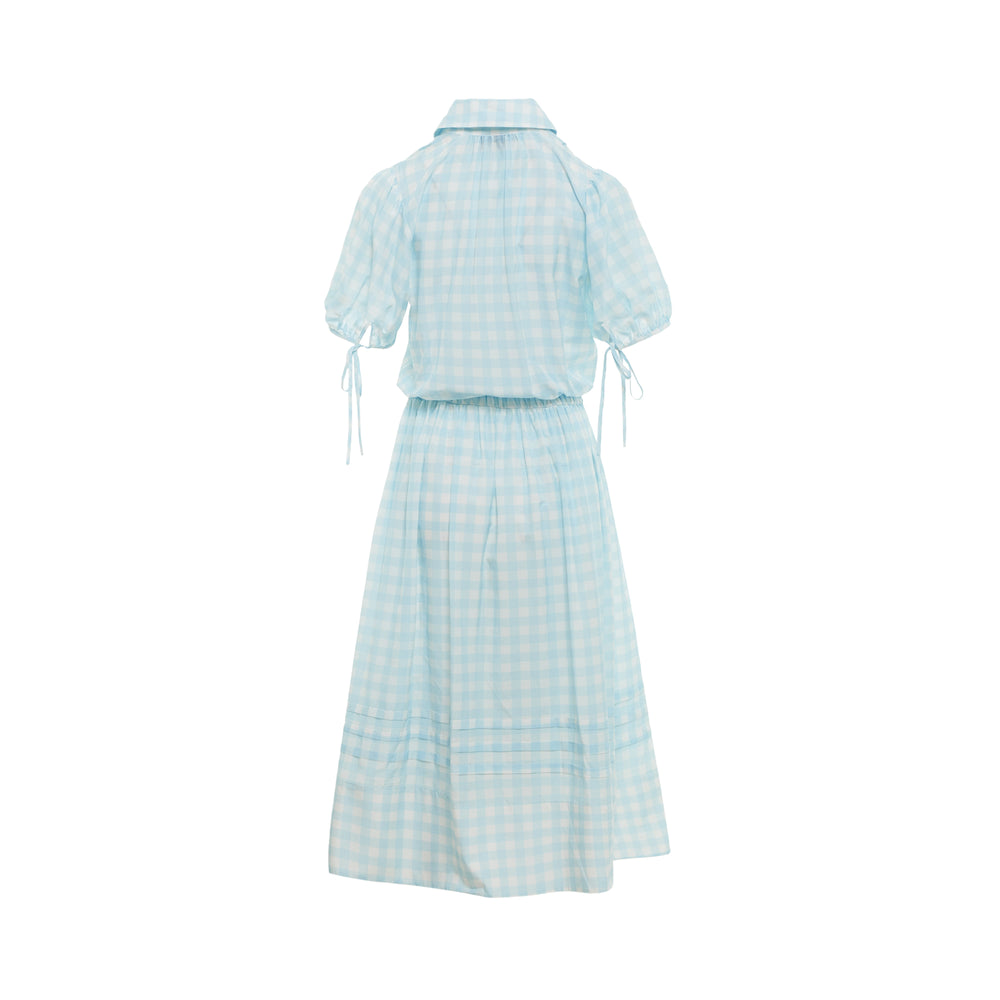 Lee Mathews Josephine Dress in light blue gingham check with Peter Pan collar, short puff sleeves, and tiered midi skirt