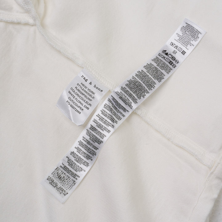 rag & bone Lucy Lace Popover Top in white with floral cutwork lace panels across the yoke and sleeve hems, open polo collar, and wide relaxed sleeves