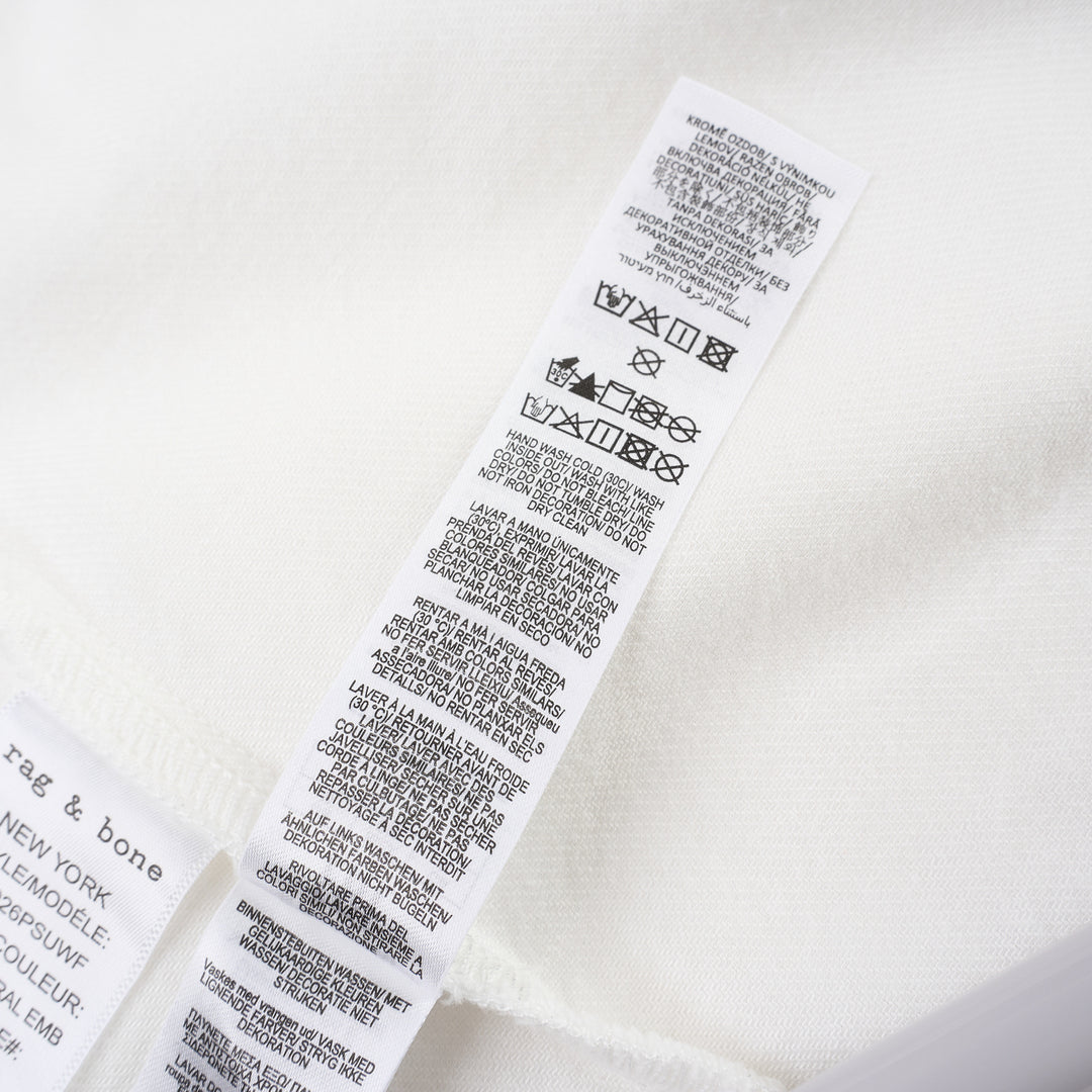 rag & bone Lucy Lace Popover Top in white with floral cutwork lace panels across the yoke and sleeve hems, open polo collar, and wide relaxed sleeves - view 4