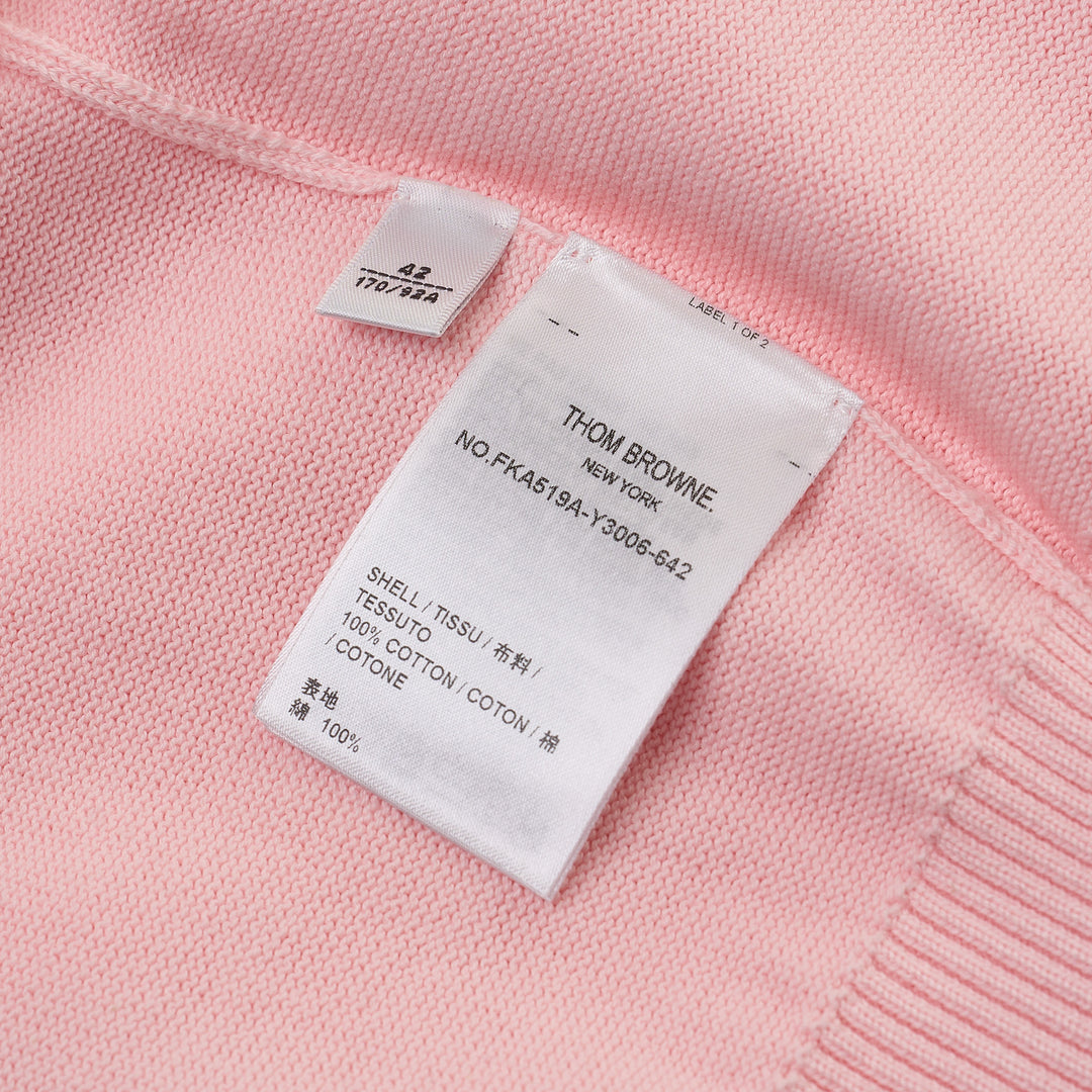 Thom Browne Short Sleeve Intarsia Knit Tee in baby pink with signature 4-bar cream stripe on the sleeve and contrast cream crew neckline, front view