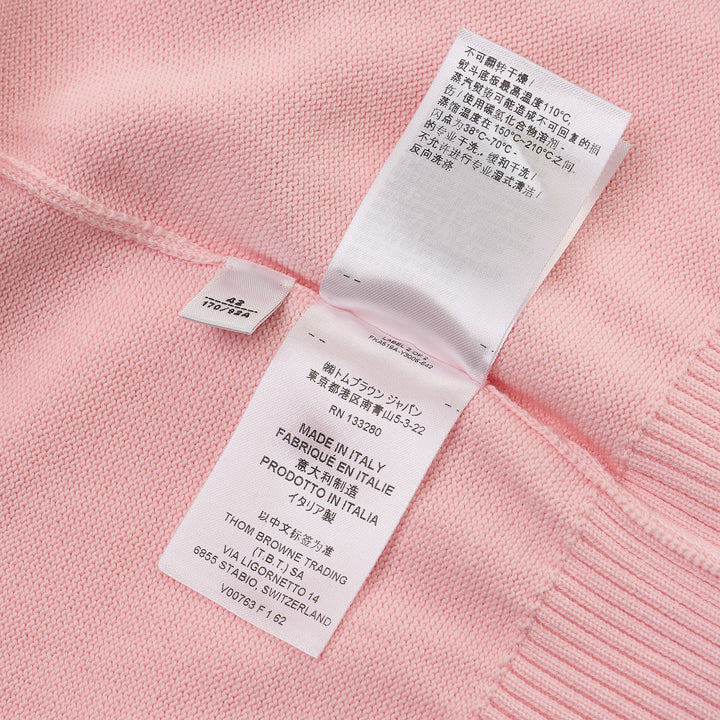 Thom Browne Short Sleeve Intarsia Knit Tee in baby pink with signature 4-bar cream stripe on the sleeve and contrast cream crew neckline, front view