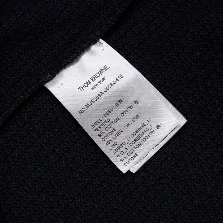 Thom Browne navy open-knit relaxed short sleeve tee with red, white, and blue striped ribbed crew neck collar and chest patch pocket