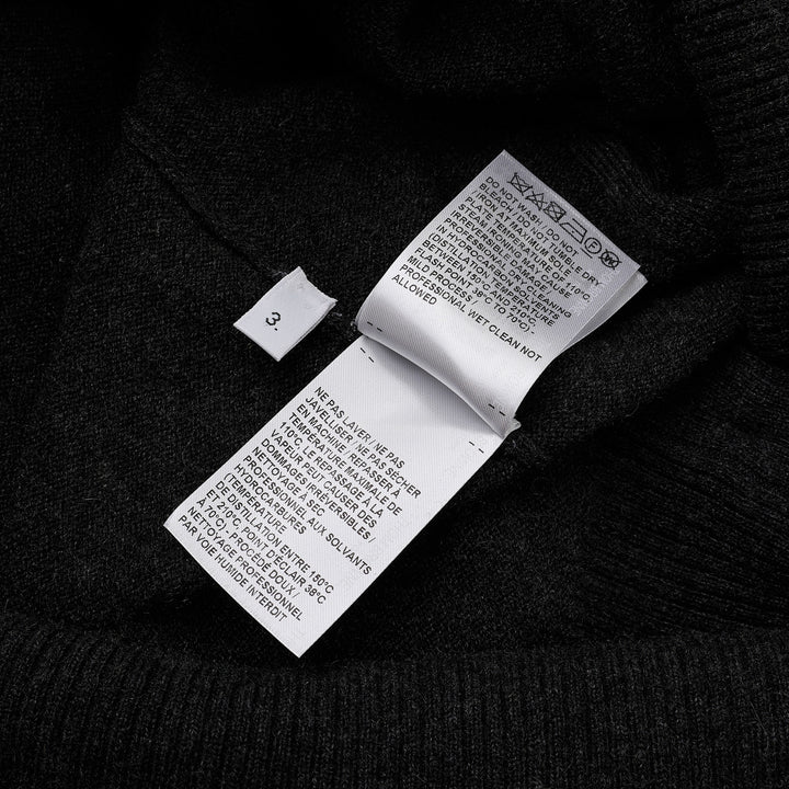 Thom Browne Classic V-Neck Cardigan in dark charcoal grey with signature four-bar white and black stripe on the sleeve, button-front closure, and ribbed hem