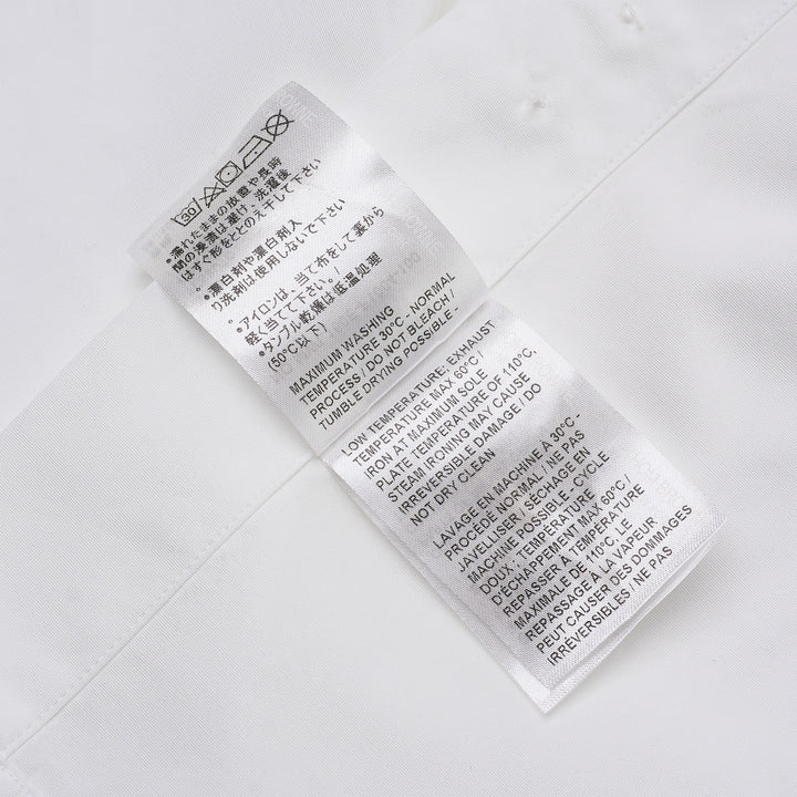 Thom Browne white long sleeve point collar shirt with signature red, white, and blue four-bar stripe on the sleeve, button-front placket, and chest pocket