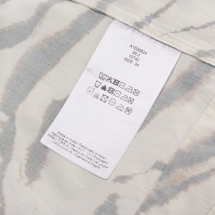 Ganni Printed Stretch Cotton Angel Dress in cream tiger-stripe print with flutter cap sleeves and button neckline, shown flat against a white background