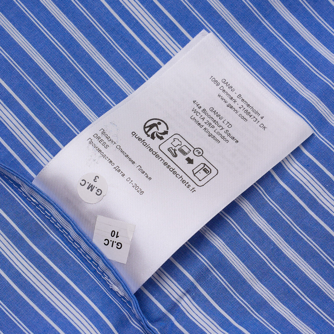 Ganni blue and white striped cotton smocked midi dress with short puff sleeves and a full pleated skirt, shown on a ghost mannequin against a white background