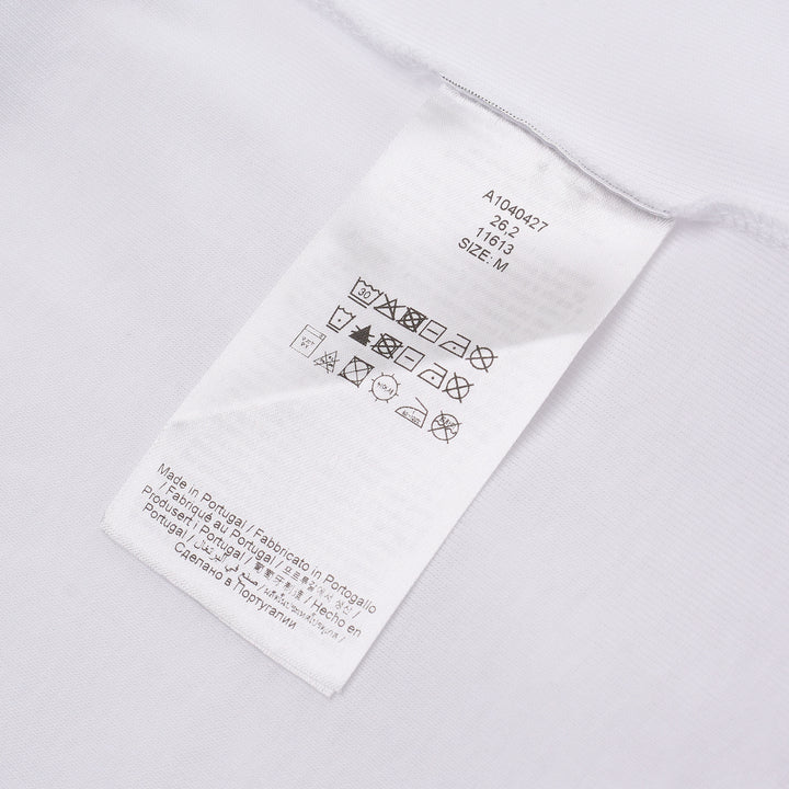 Ganni white compact rib tank top with a bold yellow banana bunch graphic, arched 'GANNI' collegiate lettering, and 'Have a nice day! Please recycle' slogan print on a white background
