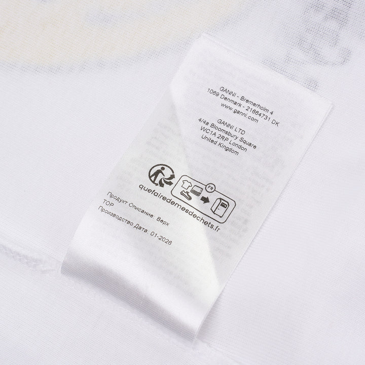 Ganni white compact rib tank top with a bold yellow banana bunch graphic, arched 'GANNI' collegiate lettering, and 'Have a nice day! Please recycle' slogan print on a white background