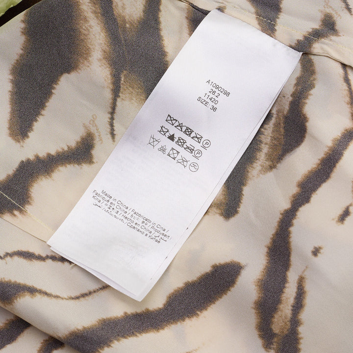 Ganni Shibori Organza Printed Skirt in sage green with overlapping zebra-stripe and red floral print, midi length with wrap tie waist, displayed flat on white background