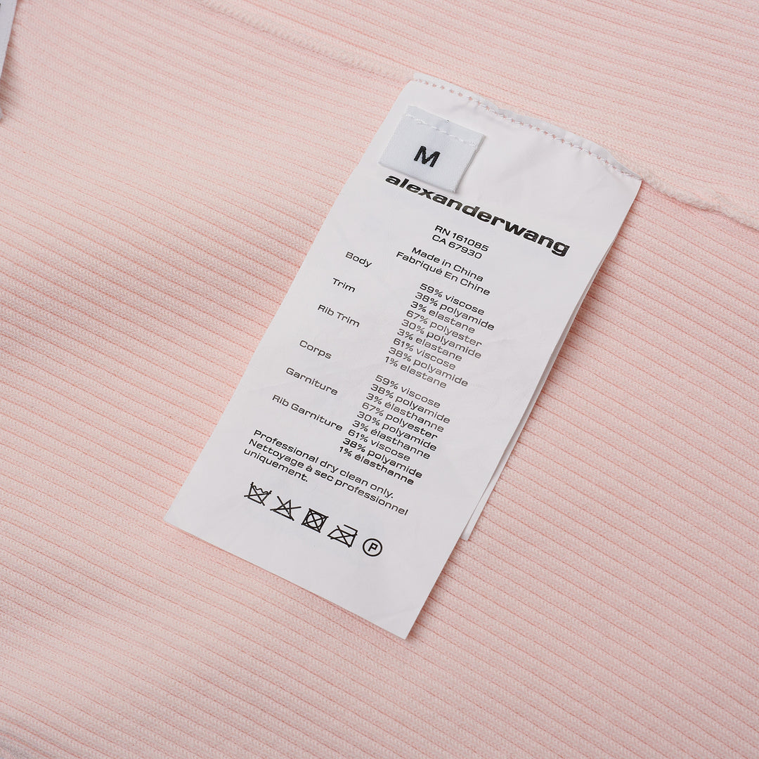 Alexander Wang pale pink ribbed-knit bike shorts with elasticated waistband and logo track strip detail, flat lay on white background
