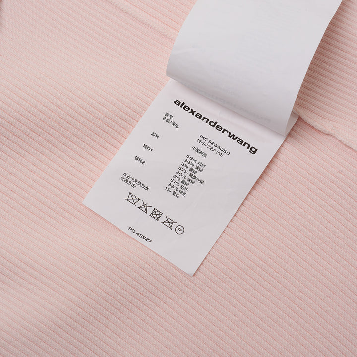 Alexander Wang pale pink ribbed-knit bike shorts with elasticated waistband and logo track strip detail, flat lay on white background