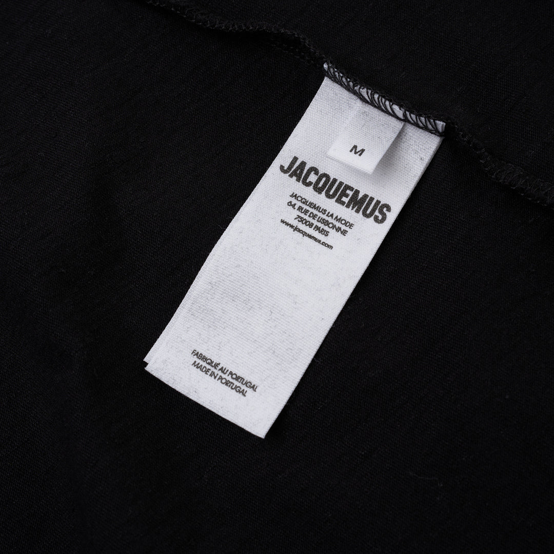Jacquemus black oversized short sleeve crew neck tee with cursive embroidered Jacquemus logo across the chest