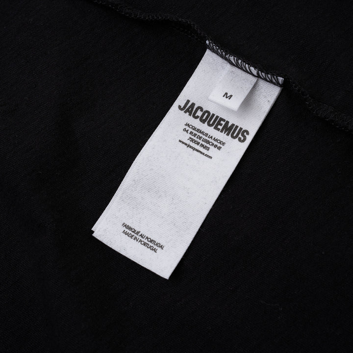 Jacquemus black oversized short sleeve crew neck tee with cursive embroidered Jacquemus logo across the chest