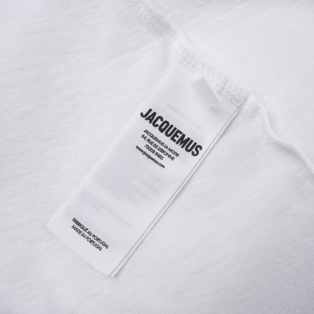 Jacquemus black oversized short sleeve crew neck tee with cursive embroidered Jacquemus logo across the chest