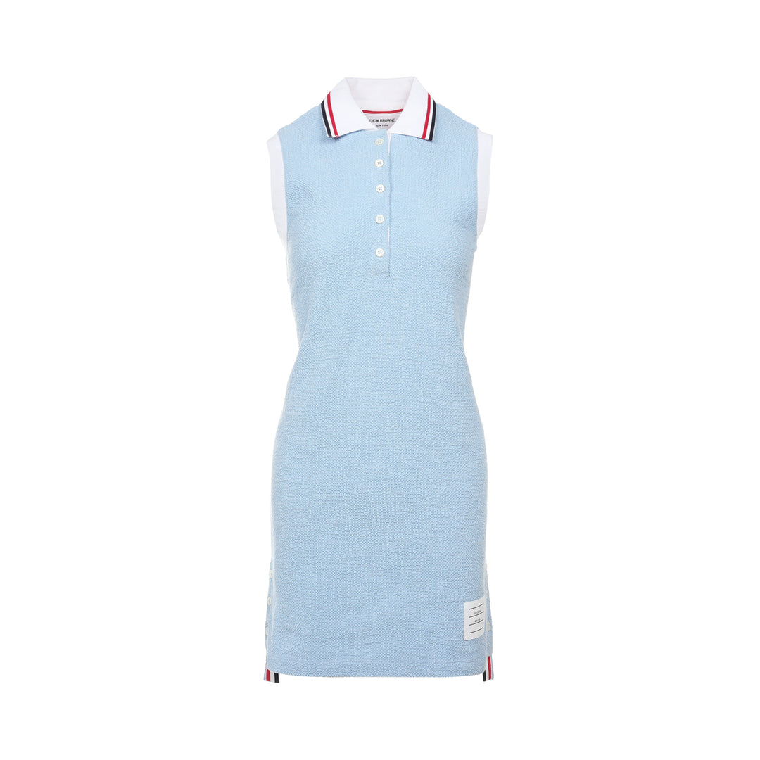 Thom Browne sleeveless polo dress in light blue bouclé with white collar featuring red, white, and blue stripe tipping, button placket, and signature 4-bar stripe at the hem