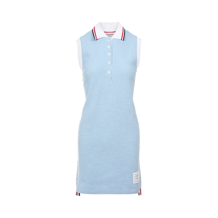 Thom Browne sleeveless polo dress in light blue bouclé with white collar featuring red, white, and blue stripe tipping, button placket, and signature 4-bar stripe at the hem