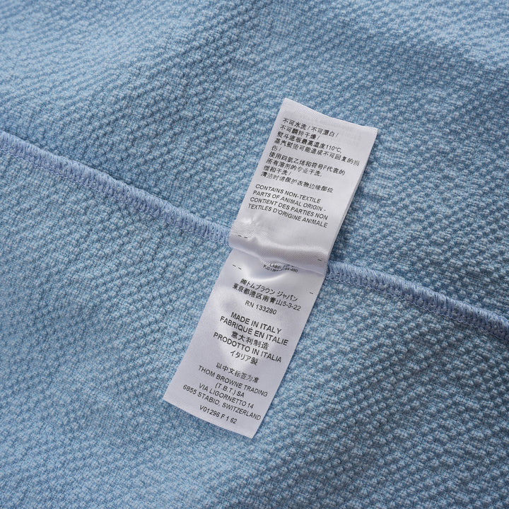 Thom Browne sleeveless polo dress in light blue bouclé with white collar featuring red, white, and blue stripe tipping, button placket, and signature 4-bar stripe at the hem - view 5