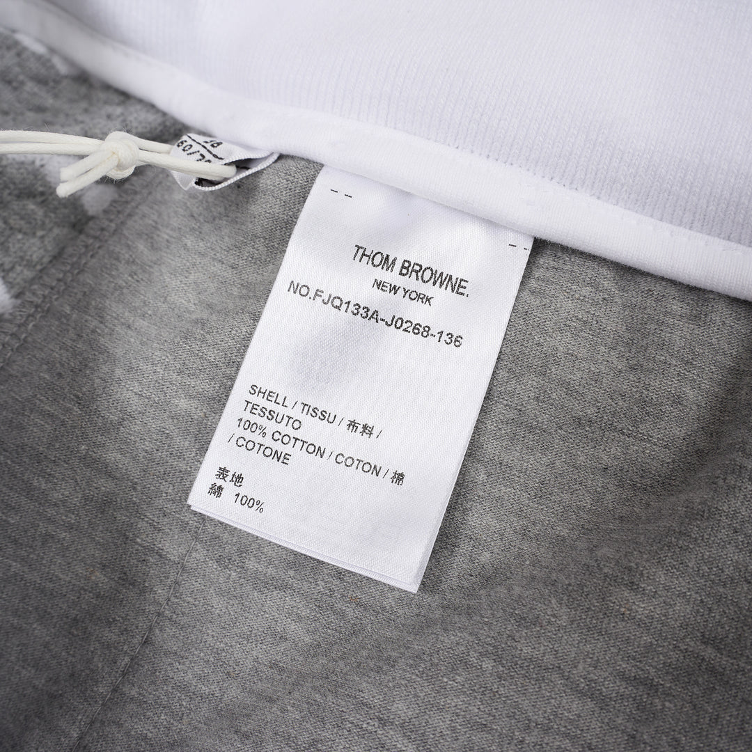 Thom Browne grey and white striped honeycomb-textured knit shorts with white ribbed waistband, drawstring tie with stripe detail, and woven brand label at hem - view 3