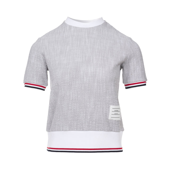 Thom Browne heather grey textural knit short sleeve tee with red, white, and blue striped tipping on sleeve cuffs and hem, white ribbed crew neck and hem band, and woven brand label on chest
