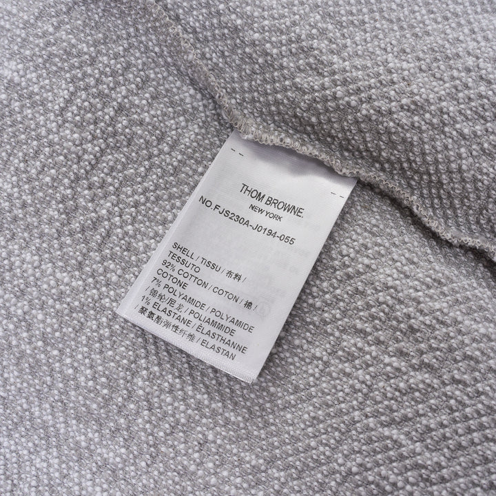 Thom Browne heather grey textural knit short sleeve tee with red, white, and blue striped tipping on sleeve cuffs and hem, white ribbed crew neck and hem band, and woven brand label on chest - view 3