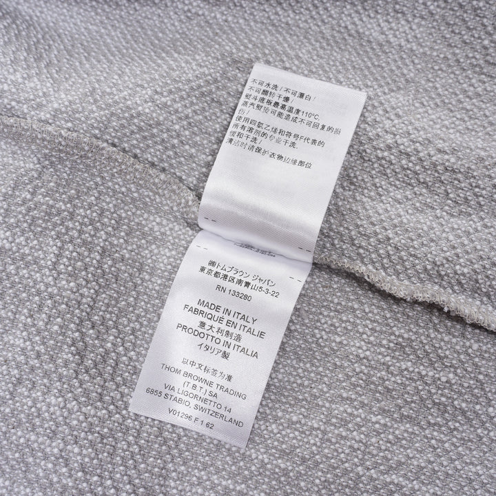 Thom Browne heather grey textural knit short sleeve tee with red, white, and blue striped tipping on sleeve cuffs and hem, white ribbed crew neck and hem band, and woven brand label on chest - view 5