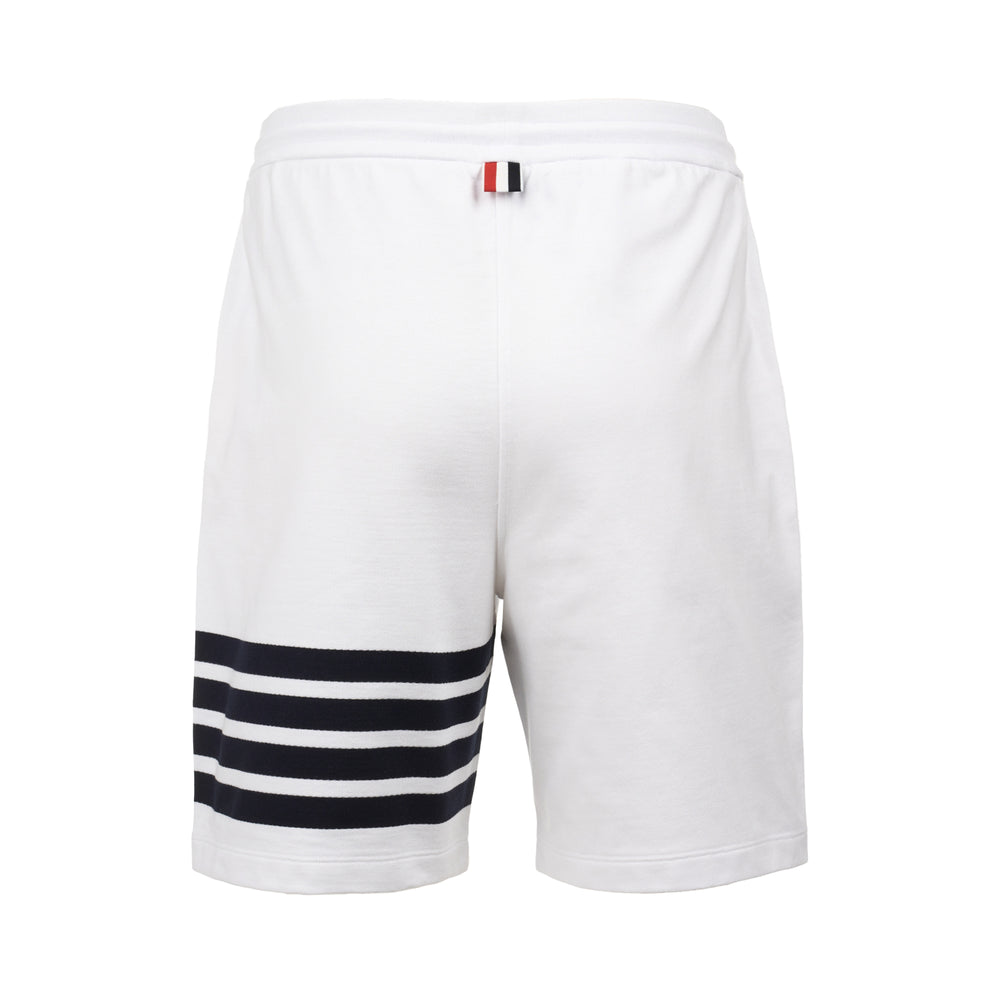 Thom Browne white loopback cotton sweat shorts with navy four-bar stripe detail at hem, drawstring waistband, and woven brand label - view 2