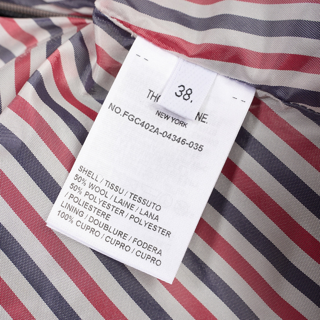 Thom Browne grey pleated mini skirt with tonal 4-bar stripe on one panel and red, white, and blue grosgrain tab at hem - view 3