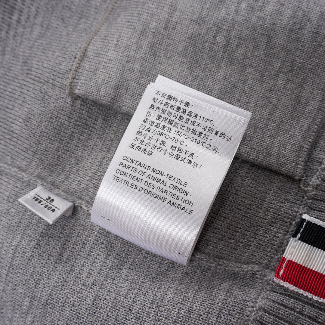 Thom Browne heather grey V-neck cardigan with four-bar white stripe detail on sleeve, button-through front, and ribbed hem and cuffs - view 6