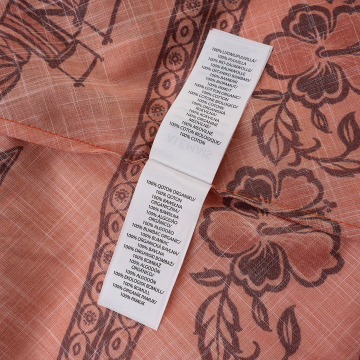 Alemais Boathouse Mini Dress in orange cotton with tropical palm and floral border print, balloon sleeves, gathered neckline with tassel tie, and coordinating rope belt