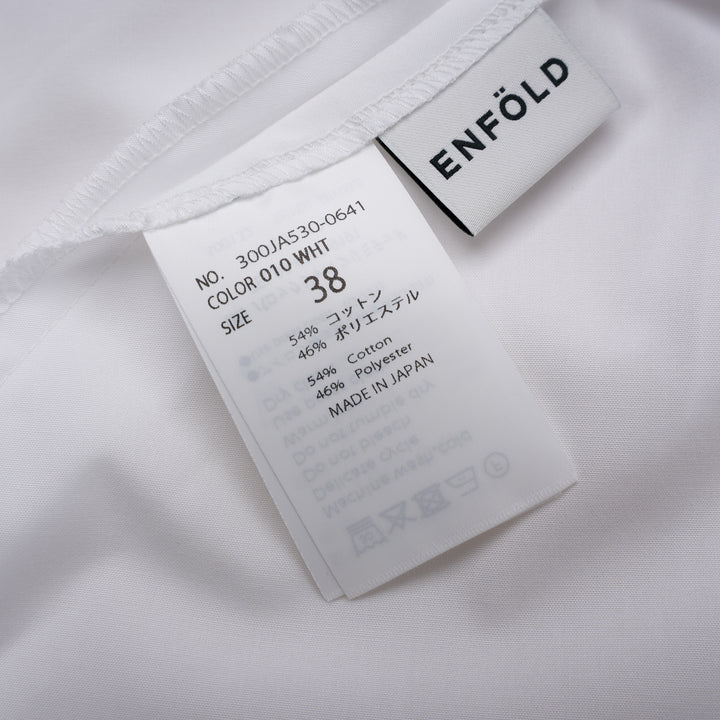 Enfold Big Collar Layered Blouse in white, rear view showing tiered cape collar, voluminous peplum hem, back zip closure, and long self-fabric waist ties