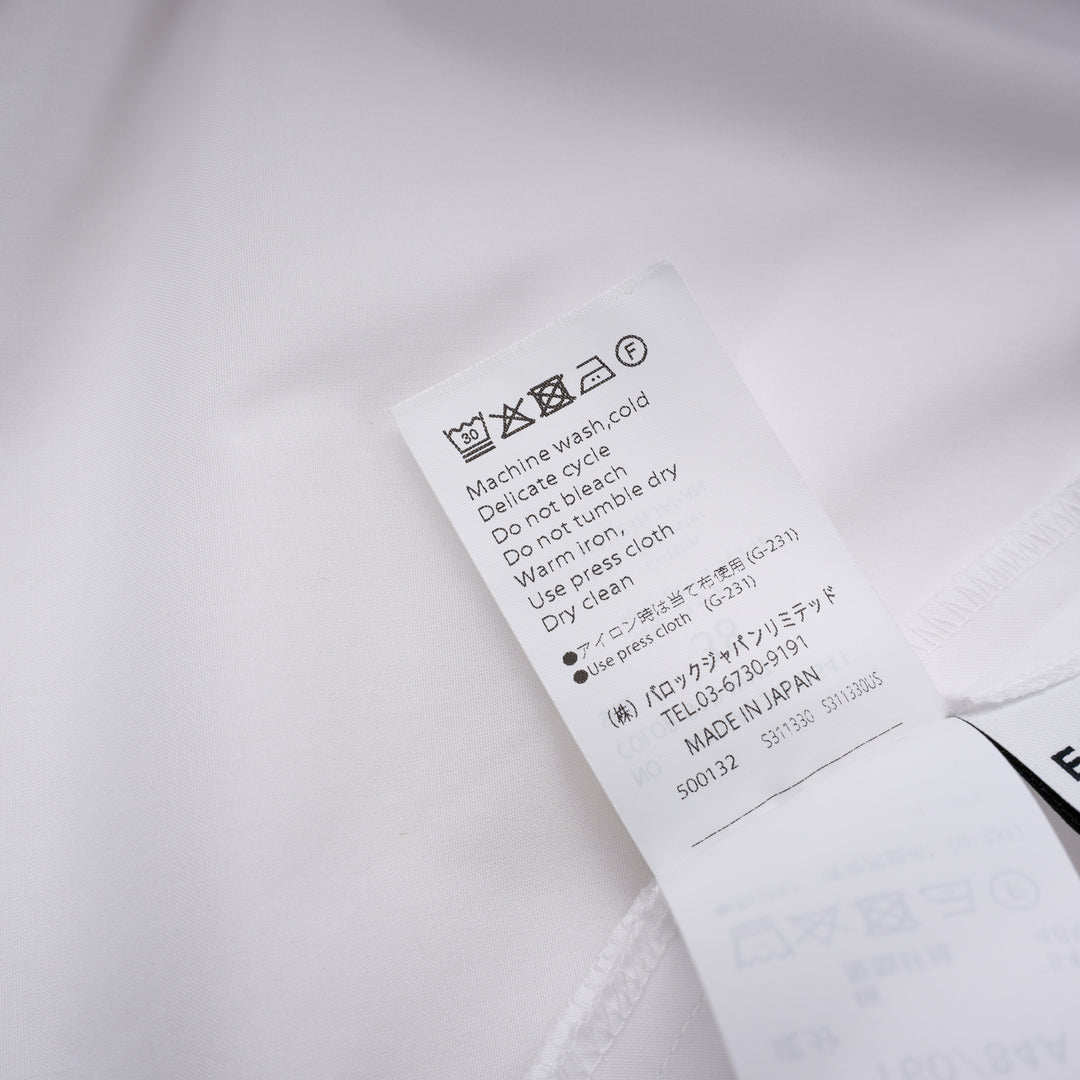 Enfold Big Collar Layered Blouse in white, rear view showing tiered cape collar, voluminous peplum hem, back zip closure, and long self-fabric waist ties