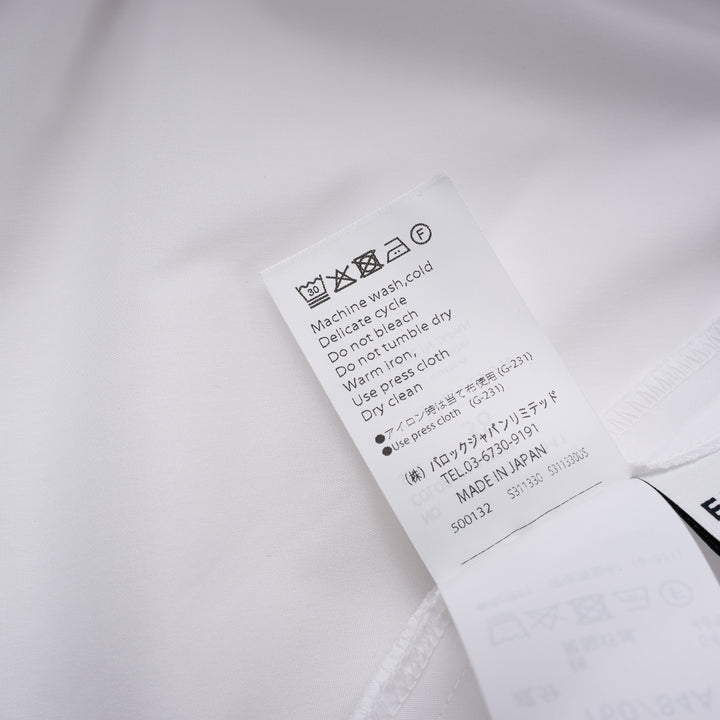 Enfold Big Collar Layered Blouse in white, rear view showing tiered cape collar, voluminous peplum hem, back zip closure, and long self-fabric waist ties
