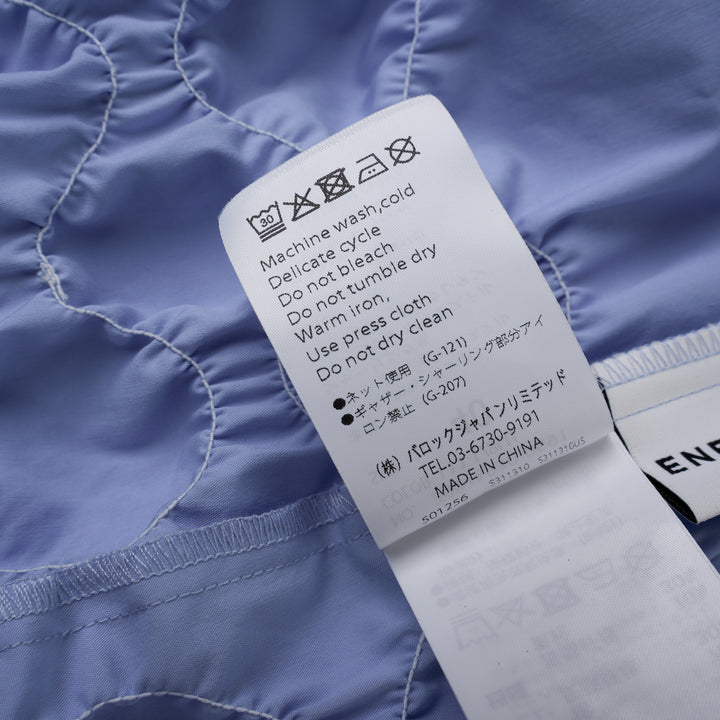 Enfold Shirring Detail Short Sleeve Shirt in periwinkle blue with elasticated smocked waist panel and mother-of-pearl buttons, front view on white background