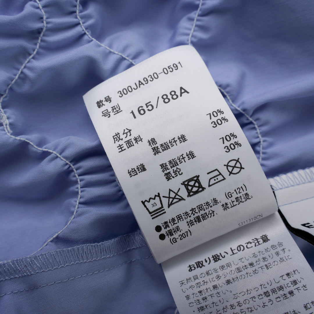 Enfold Shirring Detail Short Sleeve Shirt in periwinkle blue with elasticated smocked waist panel and mother-of-pearl buttons, front view on white background