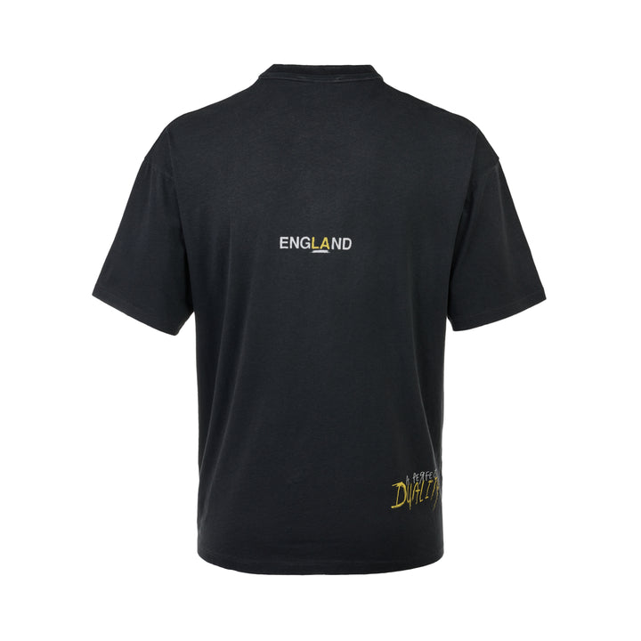 Represent Enemy Tee in washed black, featuring oversized gothic 'Represent' lettering, a hand-drawn lion and diving eagle illustration, blue flame detailing, and 'England' branding on heavyweight cotton