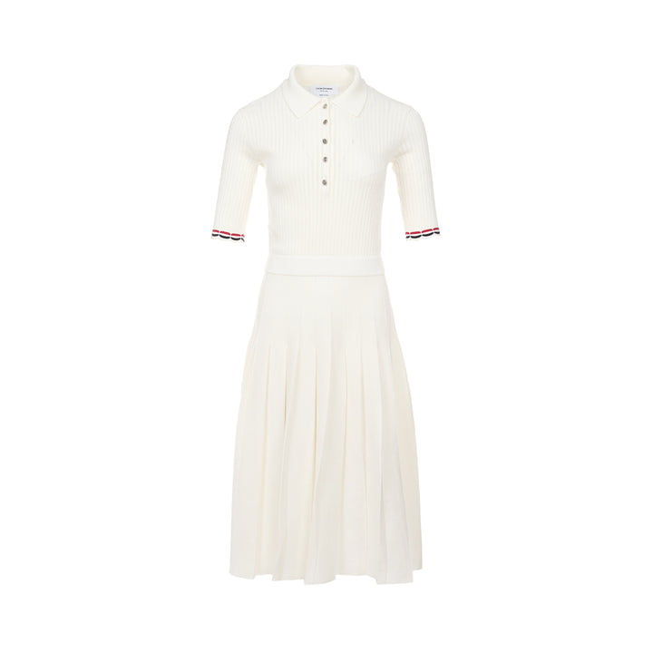 Thom Browne below knee polo dress in ivory ribbed knit with pleated skirt, silver-tone button placket, and signature red, white, and blue stripe cuff trim