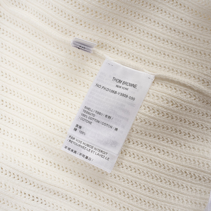 Thom Browne below knee polo dress in ivory ribbed knit with pleated skirt, silver-tone button placket, and signature red, white, and blue stripe cuff trim - view 3
