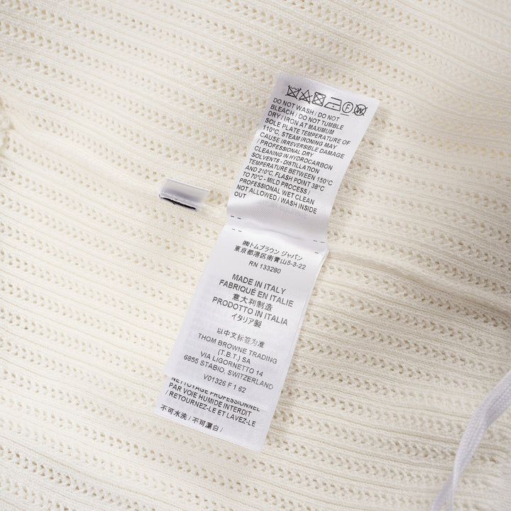 Thom Browne below knee polo dress in ivory ribbed knit with pleated skirt, silver-tone button placket, and signature red, white, and blue stripe cuff trim - view 4