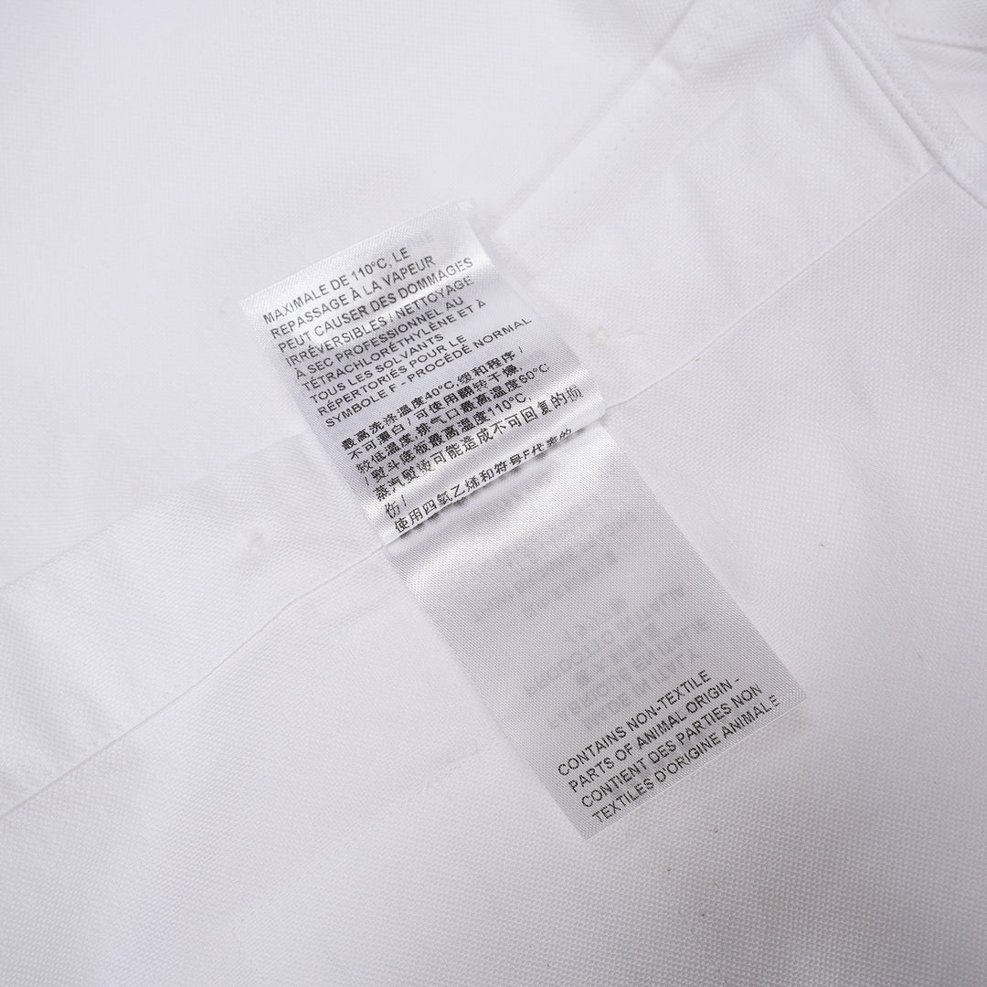 Thom Browne white oxford long sleeve shirt with rounded collar, button-front placket, single chest pocket, and signature four-bar grey stripe across one sleeve - view 5