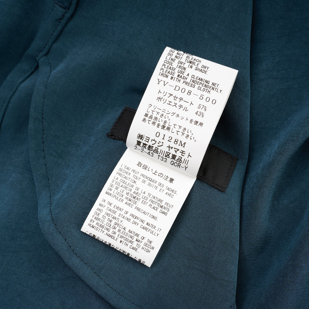 Y's teal blue gather collar shirt dress with tie neck, button front fastening, oversized patch pockets, and ribbon cuff ties, displayed flat on white background - view 4