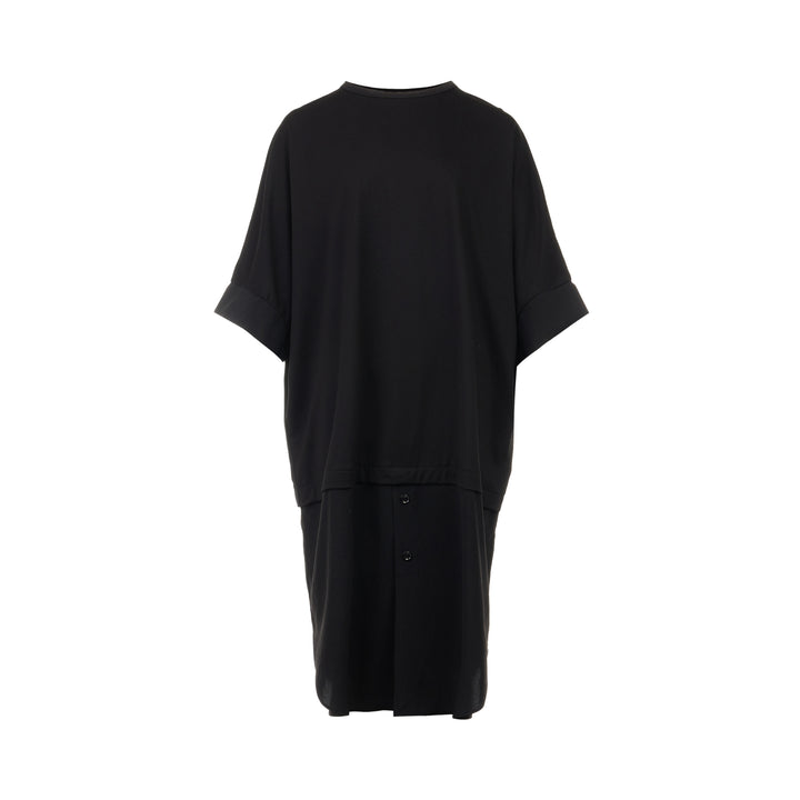Y's black oversized round neck shirt dress with short folded cuffs, layered T-shirt upper, and buttoned skirt panel, displayed on white background