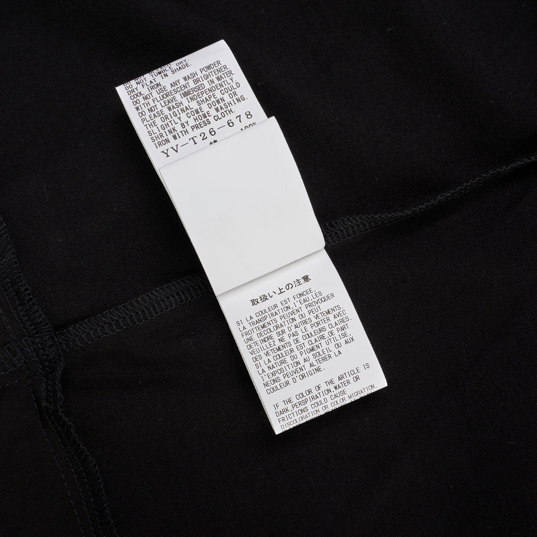 Y's black oversized round neck shirt dress with short folded cuffs, layered T-shirt upper, and buttoned skirt panel, displayed on white background - view 5