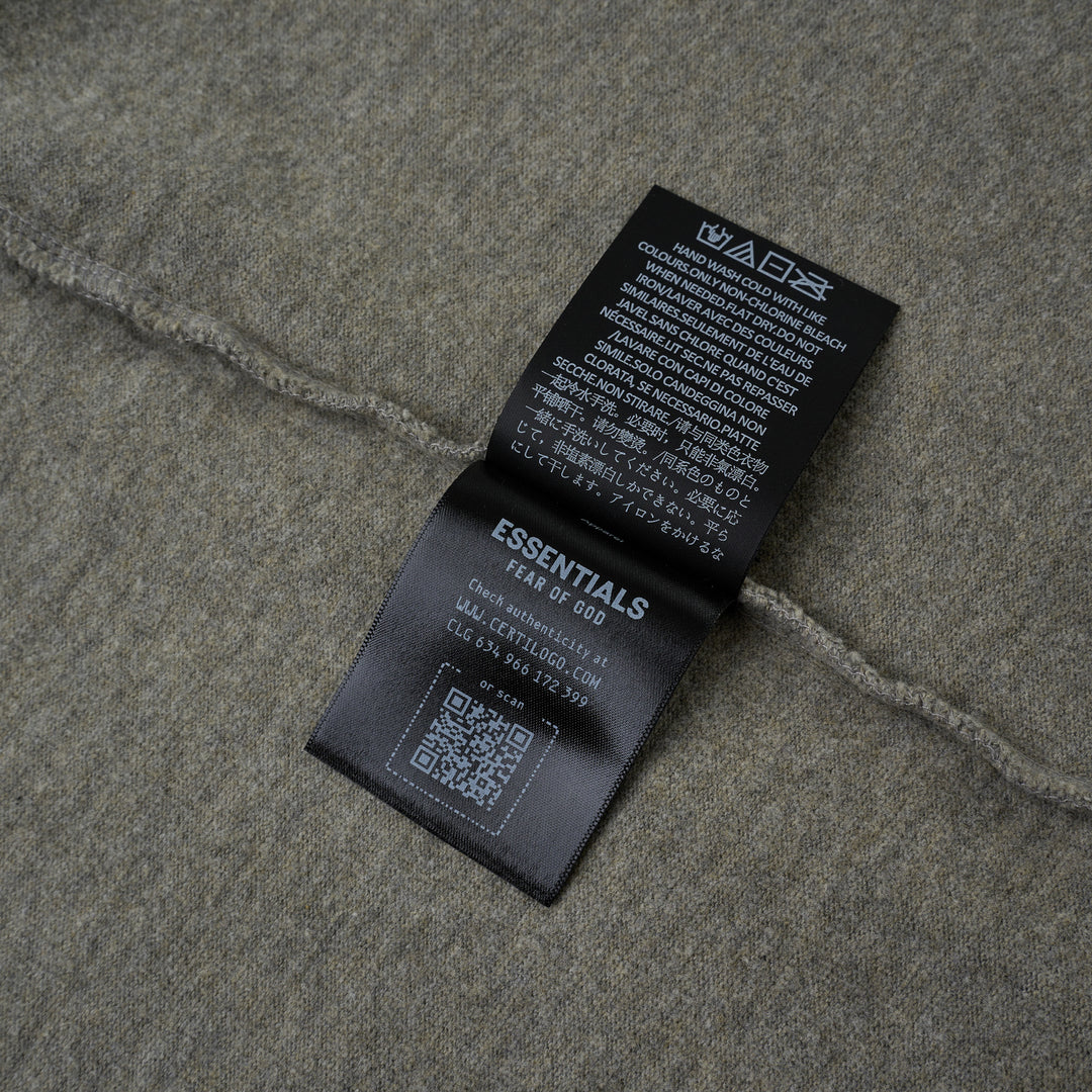 Fear of God Essentials FGE Mock Neck Tee in washed charcoal, featuring an oversized boxy silhouette, dropped shoulders, half-length sleeves, and tonal FGE chest branding