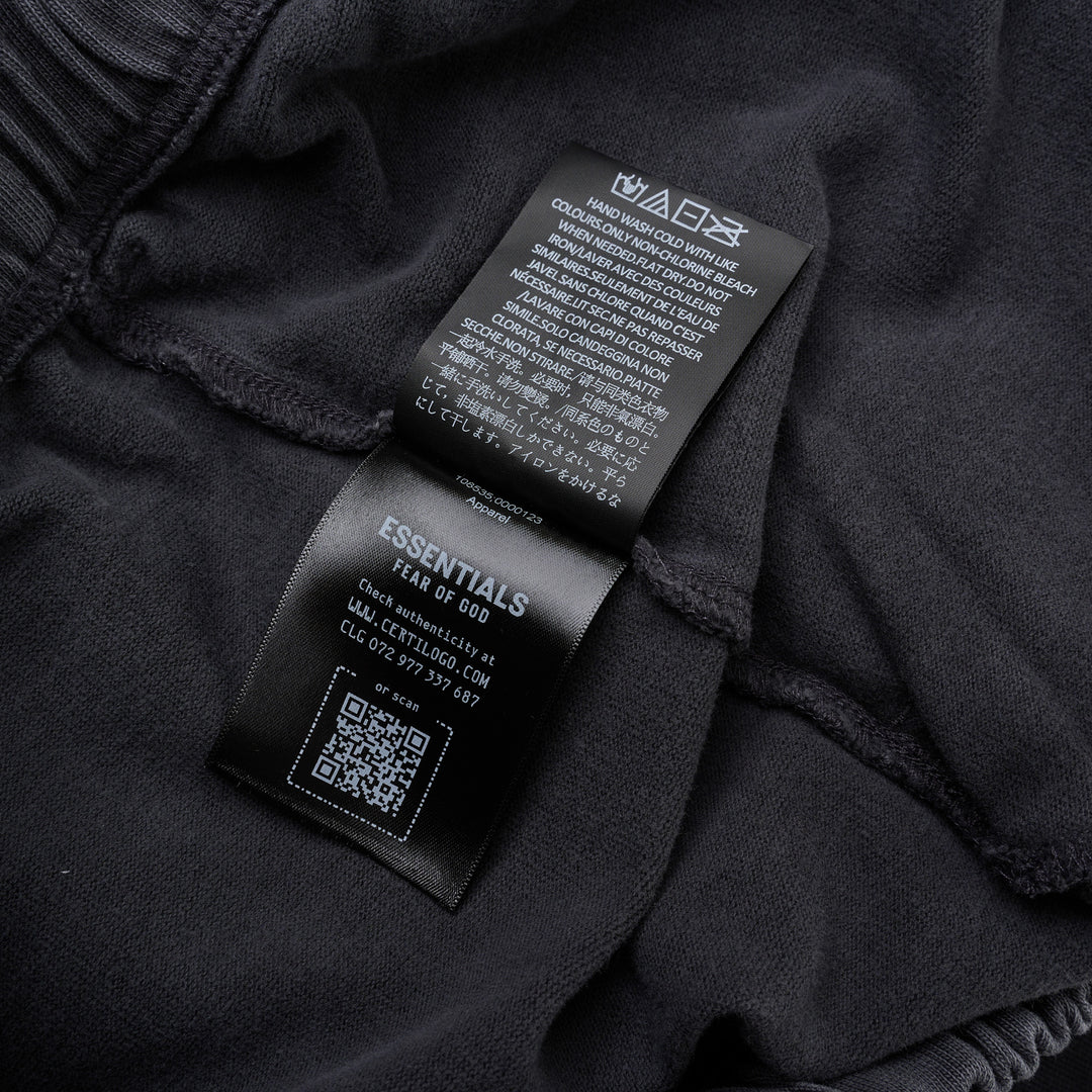 Fear of God Essentials 90s Shorts in washed charcoal with cream rope drawstring waistband and tonal logo embroidery at the hem