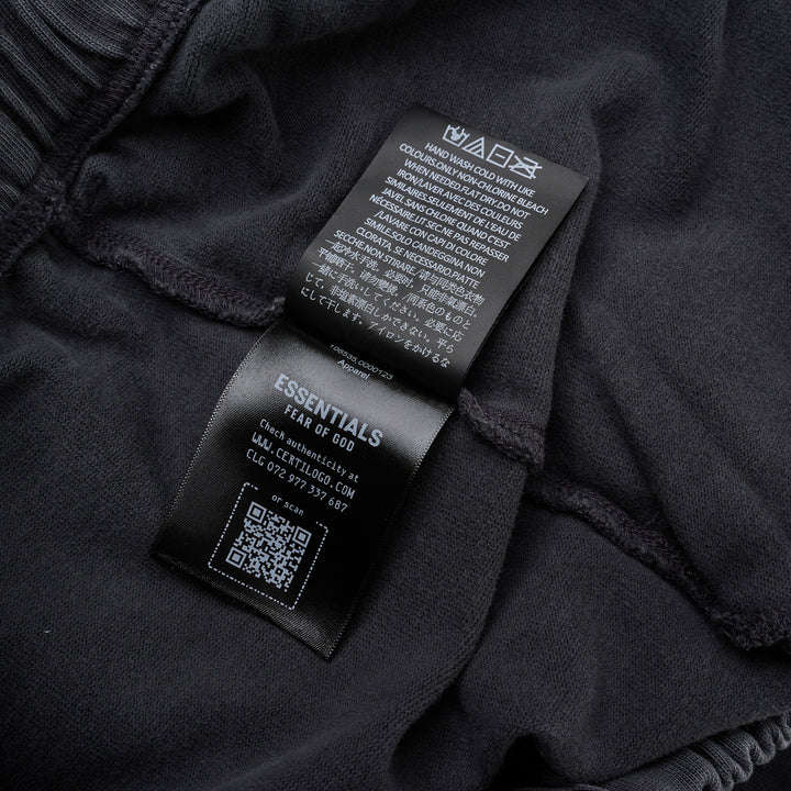 Fear of God Essentials 90s Shorts in washed charcoal with cream rope drawstring waistband and tonal logo embroidery at the hem