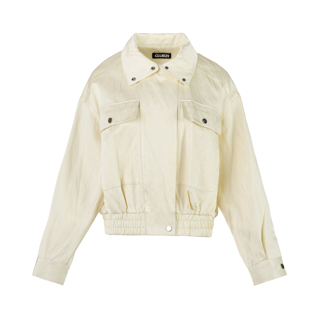 Cream cropped bomber jacket in crinkled cotton rayon with flap chest pockets, snap-button collar and elasticated hem