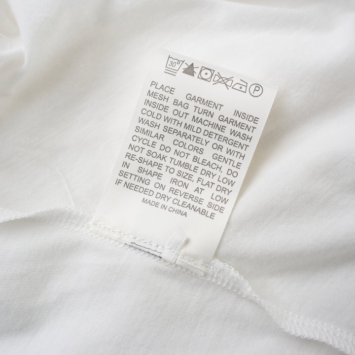 White long sleeve cotton jersey top with crew neckline, dropped shoulders and a knotted tie detail at the front hem - view 4